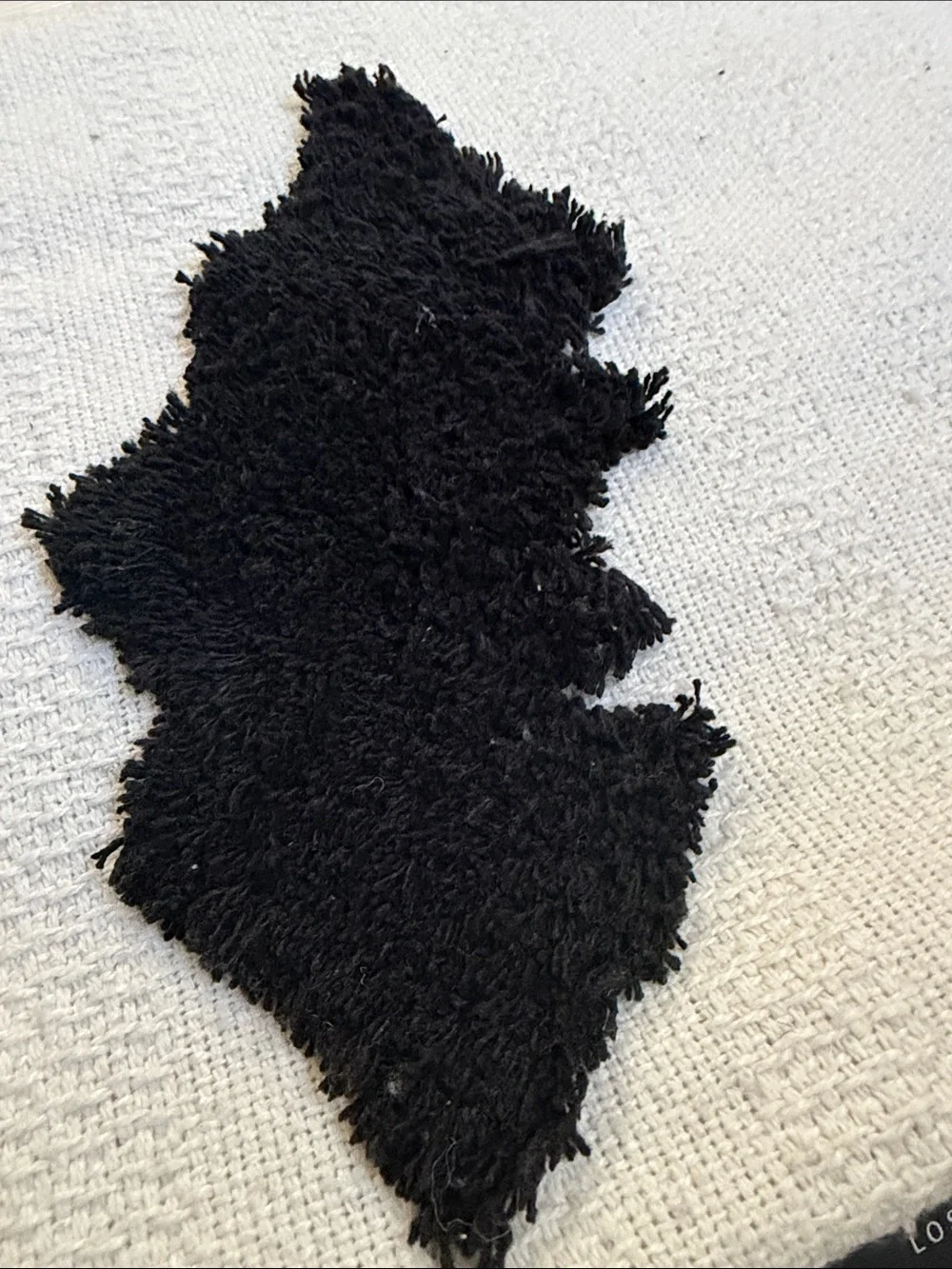 Rachel Zoe White decorative throw with Black Tufted Motifs and Tassel Accents